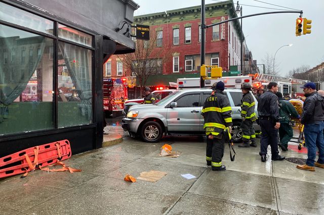 A car crashed into a building in Crown Heights, smashing the gate of a bar on April 6, 2021.